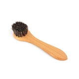 Wooden brush with bristle head on a white background