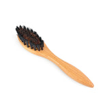 Wooden brush with black bristles on a white background