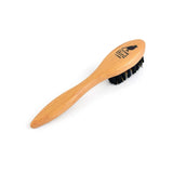 Wooden brush with black bristles on a white background