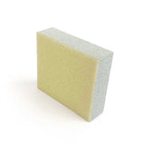 Rectangular sanding block with sandpaper surface on a white background