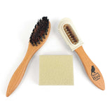 Two wooden brushes with bristles and a cloth on a white background
