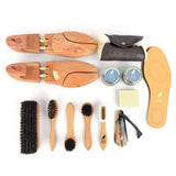 Collection of shoe care tools including brushes, cloths, and a shoe shine kit on a white background.